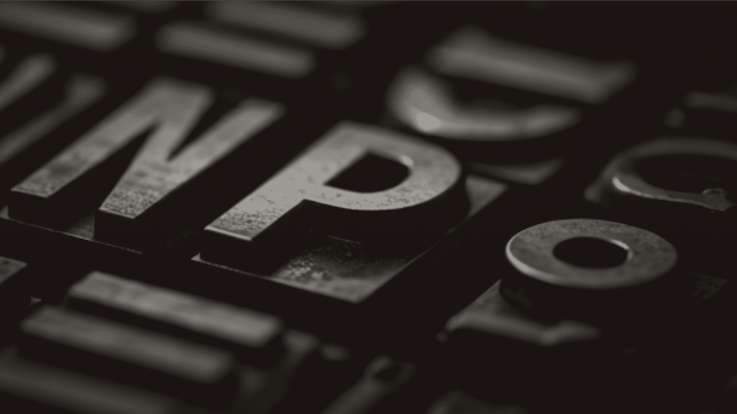 Metal letterpress type blocks in atmospheric studio lighting